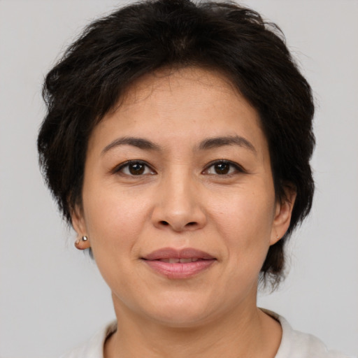 Joyful asian adult female with short  brown hair and brown eyes