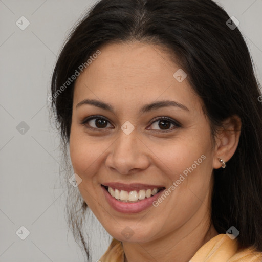 Joyful latino young-adult female with long  brown hair and brown eyes