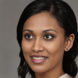 Joyful black young-adult female with medium  brown hair and brown eyes