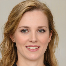 Joyful white young-adult female with long  brown hair and green eyes