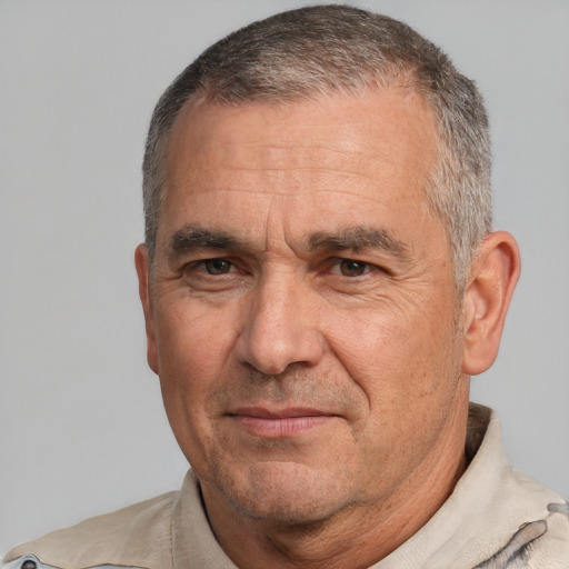 Joyful white middle-aged male with short  gray hair and brown eyes