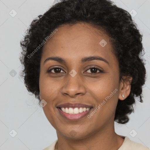 Joyful black young-adult female with long  brown hair and brown eyes