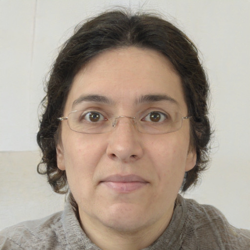 Joyful white adult female with medium  brown hair and green eyes