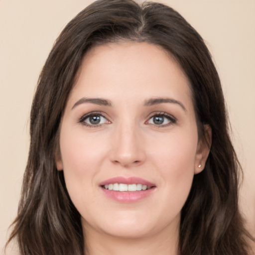 Joyful white young-adult female with long  brown hair and brown eyes