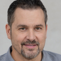 Joyful white adult male with short  brown hair and brown eyes