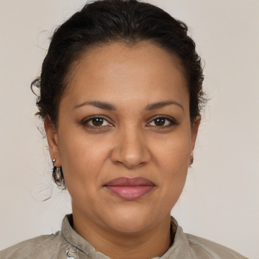 Joyful latino adult female with medium  brown hair and brown eyes