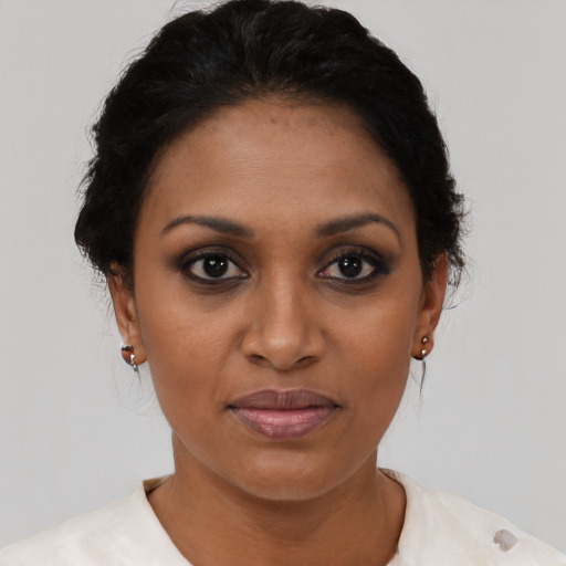 Joyful black young-adult female with short  brown hair and brown eyes