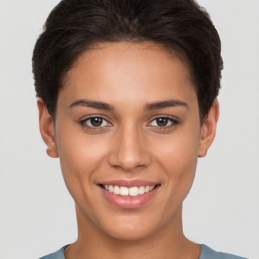 Joyful white young-adult female with short  brown hair and brown eyes