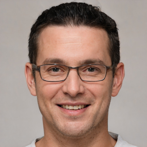 Joyful white adult male with short  brown hair and brown eyes