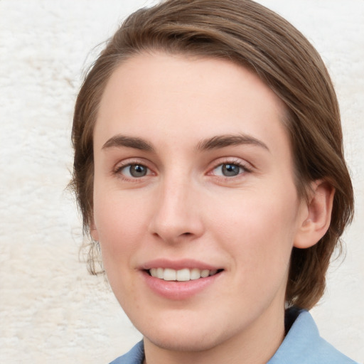 Joyful white young-adult female with medium  brown hair and blue eyes