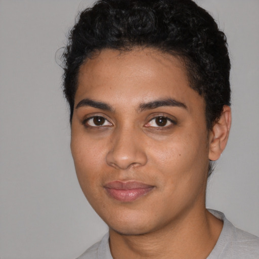 Joyful latino young-adult female with short  black hair and brown eyes
