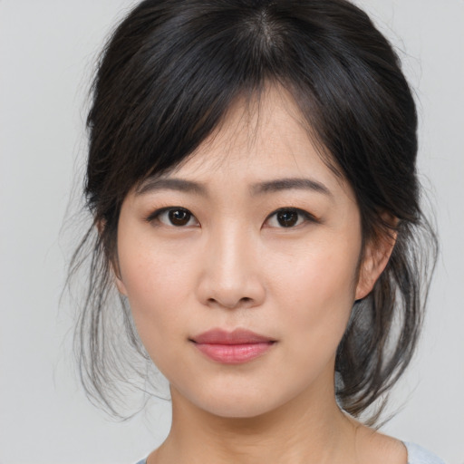 Joyful asian young-adult female with medium  brown hair and brown eyes