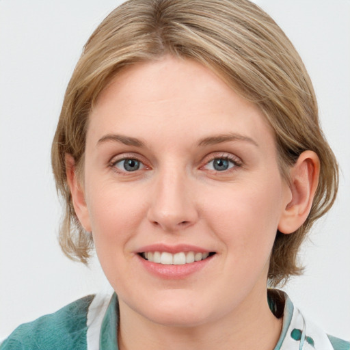 Joyful white young-adult female with medium  brown hair and blue eyes