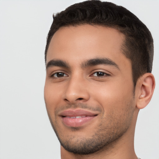 Joyful white young-adult male with short  black hair and brown eyes