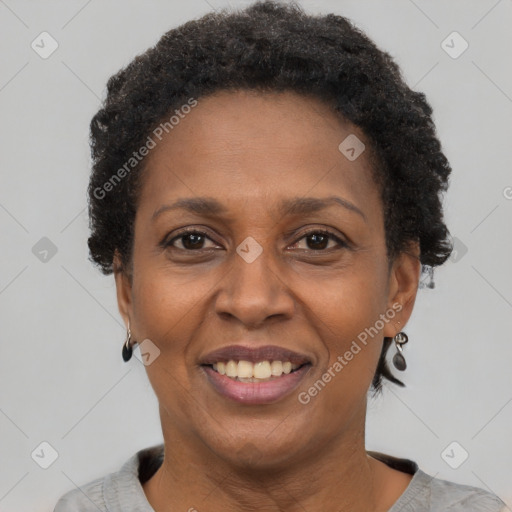 Joyful black adult female with short  brown hair and brown eyes