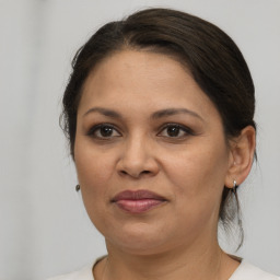 Joyful white adult female with medium  brown hair and brown eyes