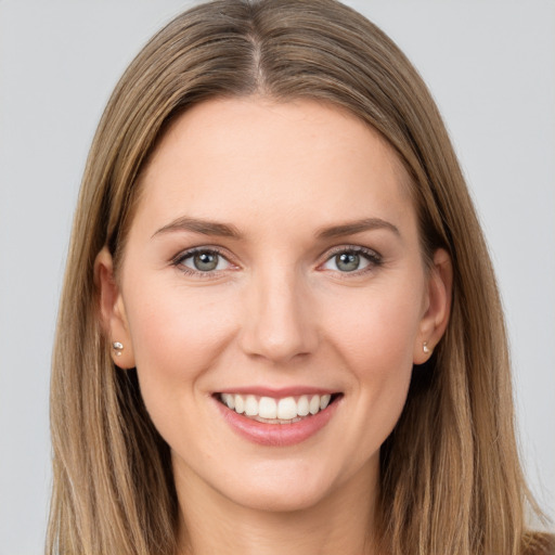 Joyful white young-adult female with long  brown hair and grey eyes