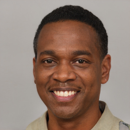 Joyful latino adult male with short  black hair and brown eyes