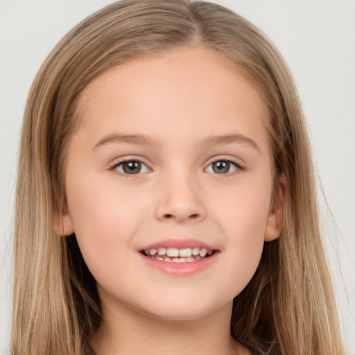 Joyful white child female with long  brown hair and brown eyes