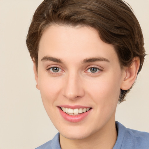 Joyful white young-adult female with short  brown hair and grey eyes