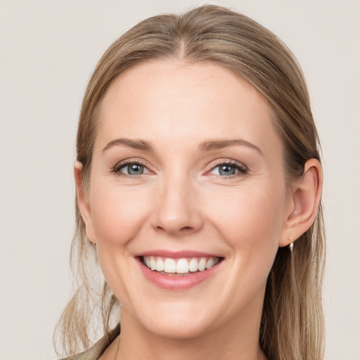 Joyful white young-adult female with long  brown hair and grey eyes