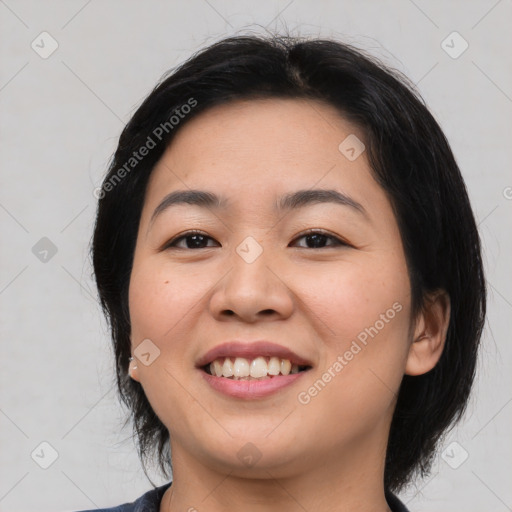 Joyful asian young-adult female with medium  black hair and brown eyes