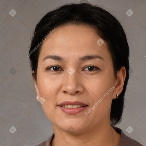 Joyful latino adult female with medium  brown hair and brown eyes