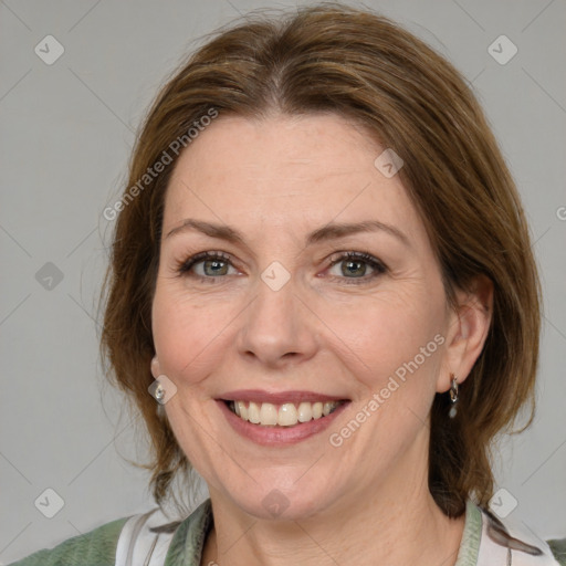 Joyful white adult female with medium  brown hair and blue eyes