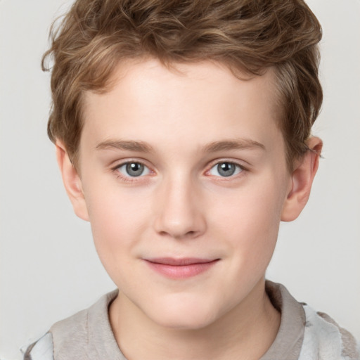 Joyful white child male with short  brown hair and grey eyes