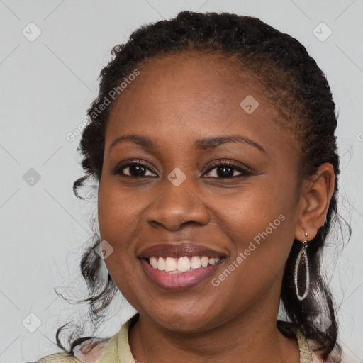 Joyful black young-adult female with medium  brown hair and brown eyes