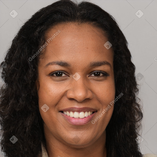 Joyful black young-adult female with long  brown hair and brown eyes