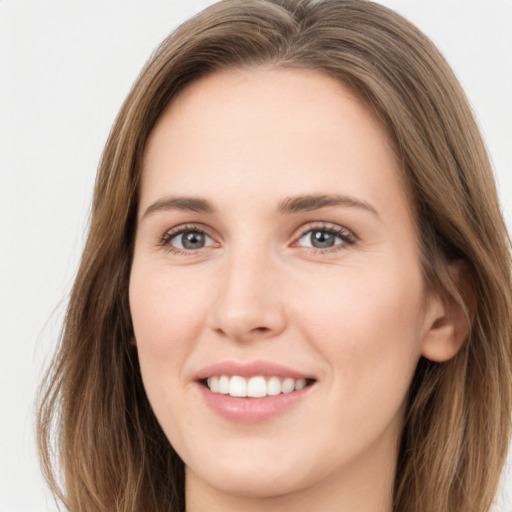 Joyful white young-adult female with long  brown hair and green eyes