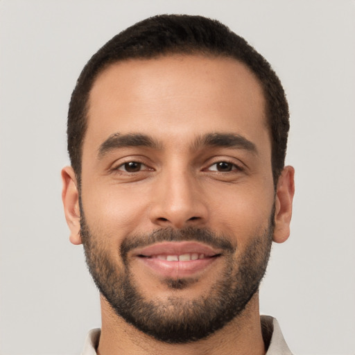 Joyful white young-adult male with short  brown hair and brown eyes