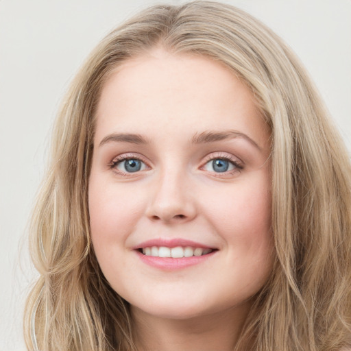 Joyful white young-adult female with long  brown hair and blue eyes