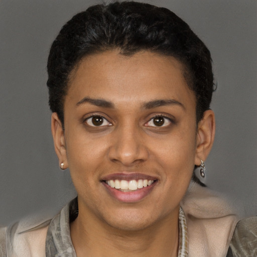 Joyful black young-adult female with short  brown hair and brown eyes