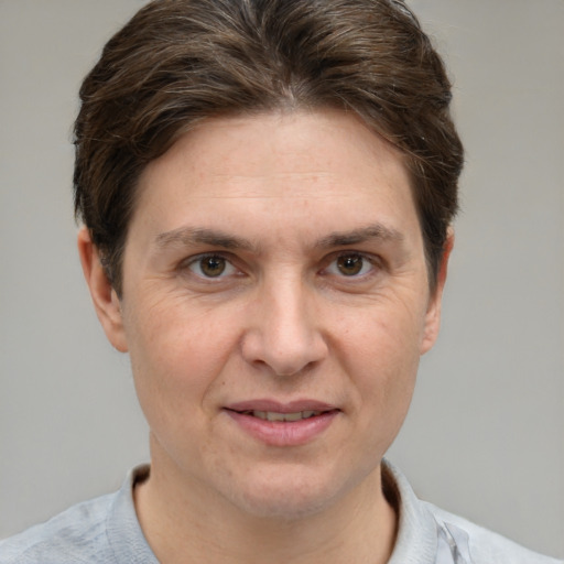 Joyful white adult female with short  brown hair and grey eyes