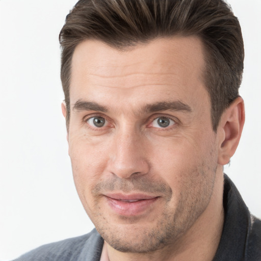 Joyful white adult male with short  brown hair and brown eyes