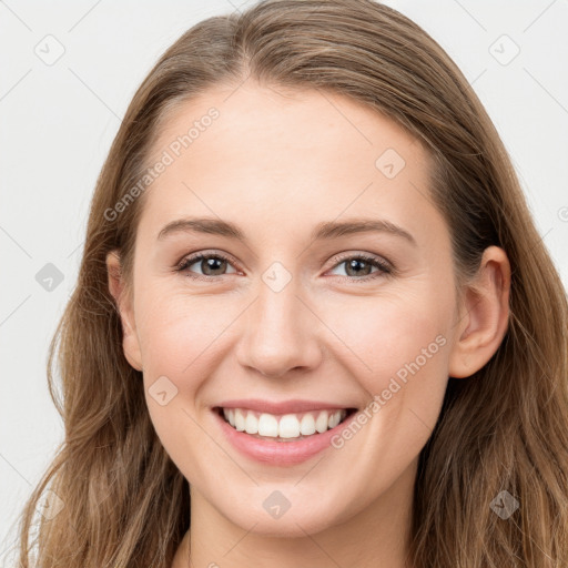 Joyful white young-adult female with long  brown hair and grey eyes