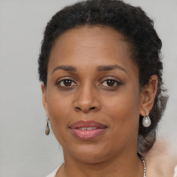 Joyful black adult female with short  brown hair and brown eyes