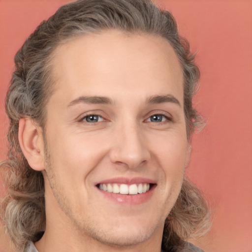 Joyful white young-adult male with medium  brown hair and brown eyes