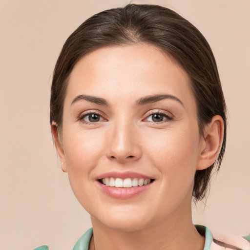 Joyful white young-adult female with medium  brown hair and brown eyes