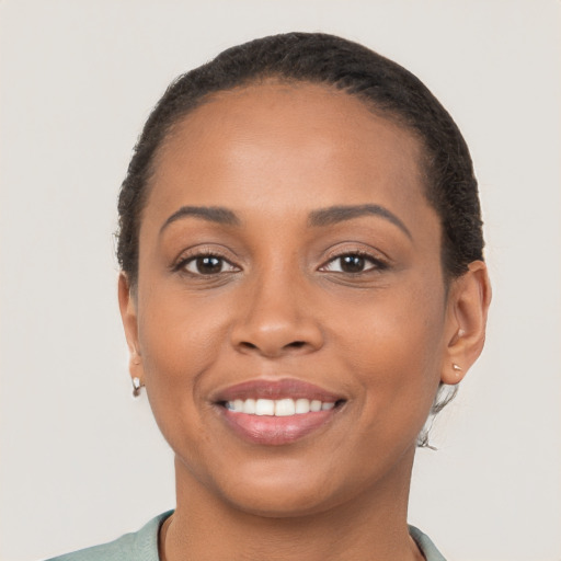 Joyful latino young-adult female with short  brown hair and brown eyes