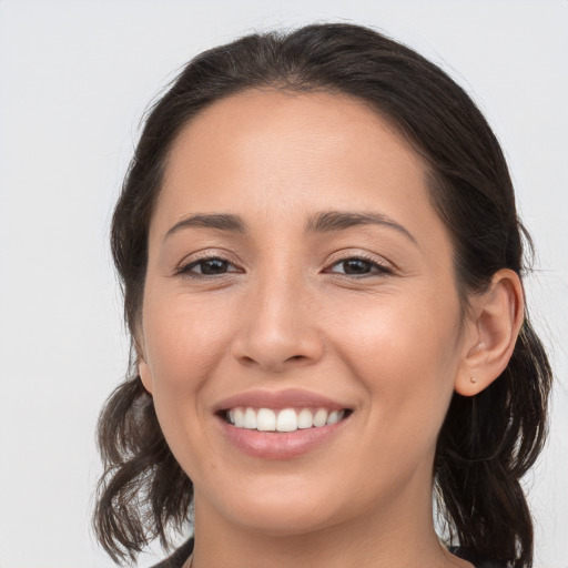 Joyful white young-adult female with medium  brown hair and brown eyes