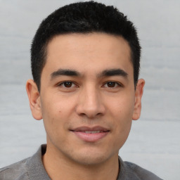 Joyful latino young-adult male with short  brown hair and brown eyes