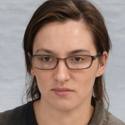 Joyful white adult female with medium  brown hair and grey eyes