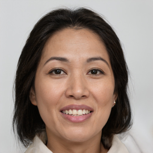 Joyful white adult female with medium  brown hair and brown eyes