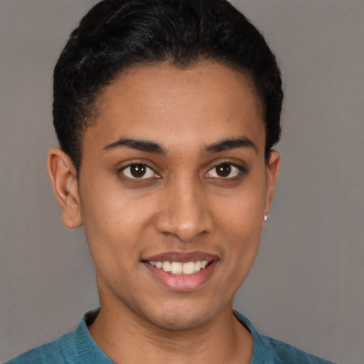 Joyful latino young-adult male with short  black hair and brown eyes