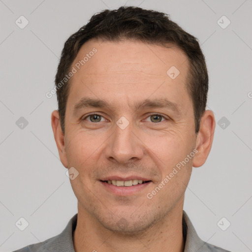 Joyful white adult male with short  brown hair and brown eyes