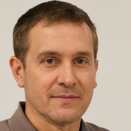 Joyful white adult male with short  brown hair and brown eyes