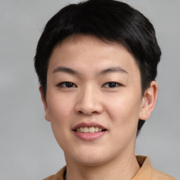 Joyful asian young-adult female with short  black hair and brown eyes